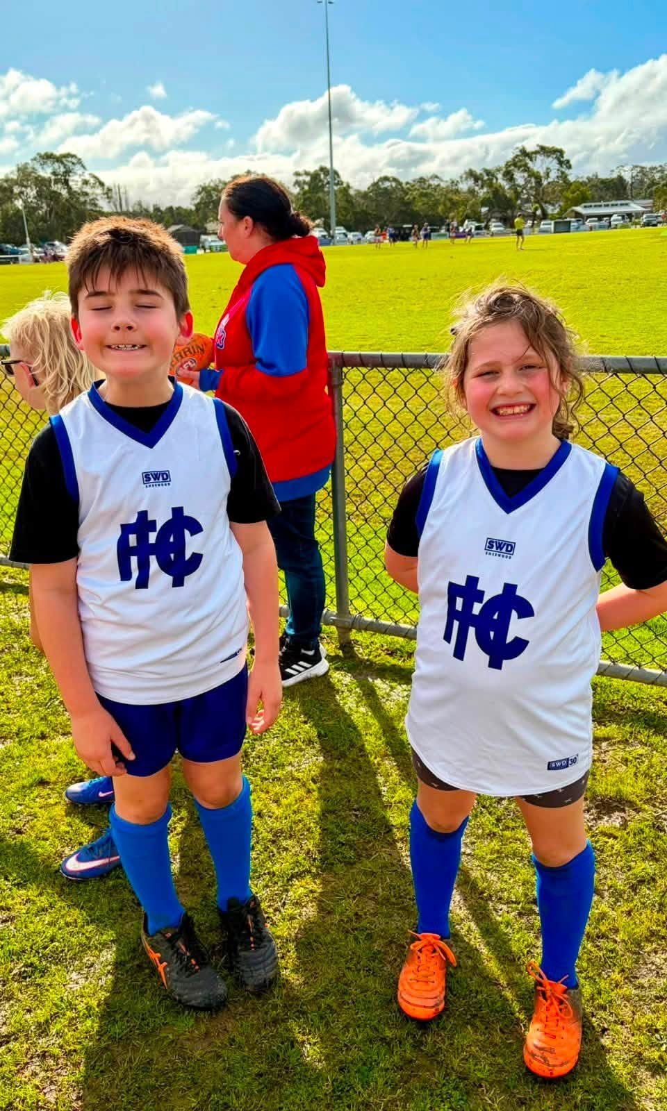 Two juniors in Hastings training tops smile for the camera.