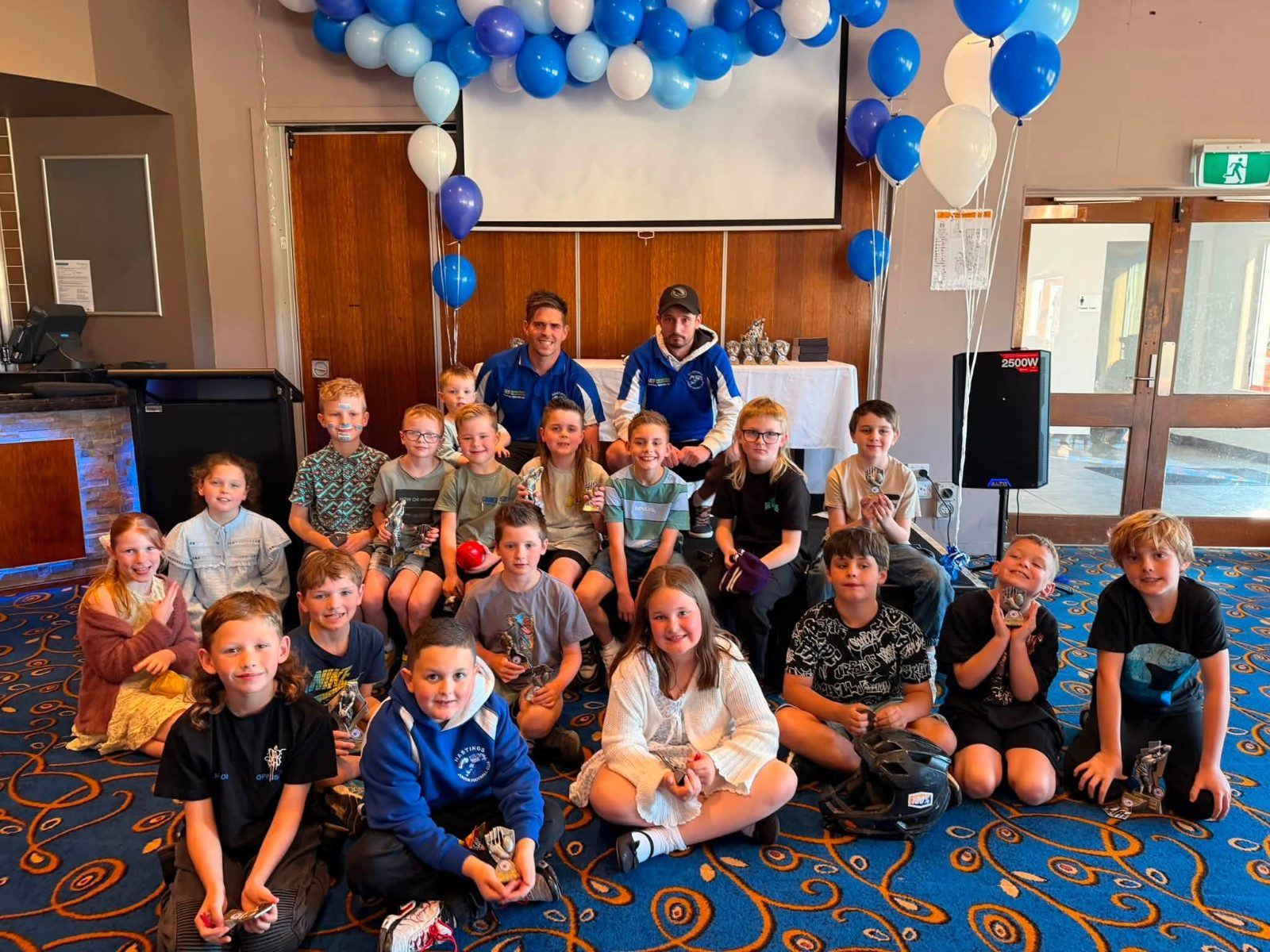 Hastings juniors and families crowd the clubrooms on presentation day, decorated with blue and white balloons.