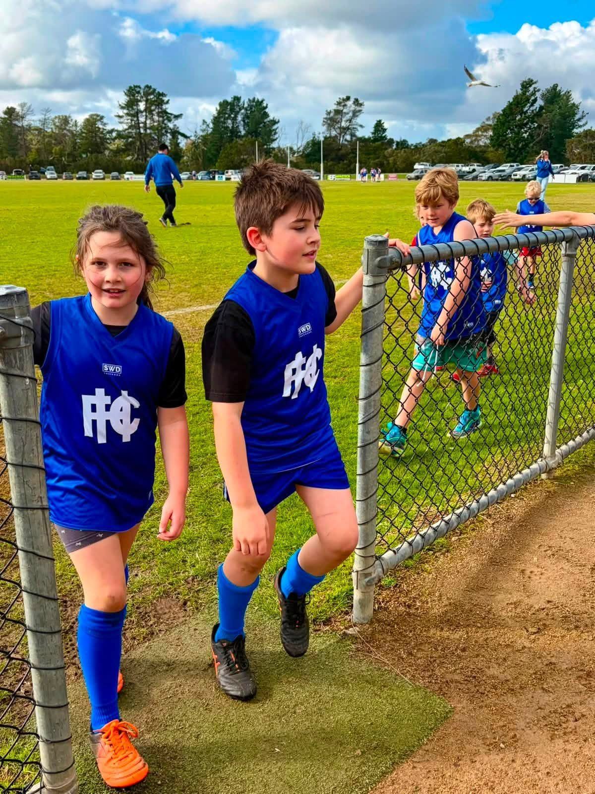 Two Hastings juniors walk out onto the ground together.